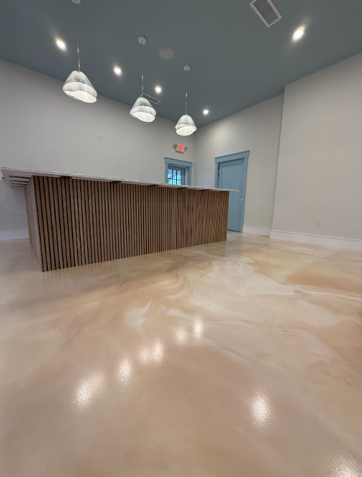 Cream metallic epoxy floor in a commercial office reception area
