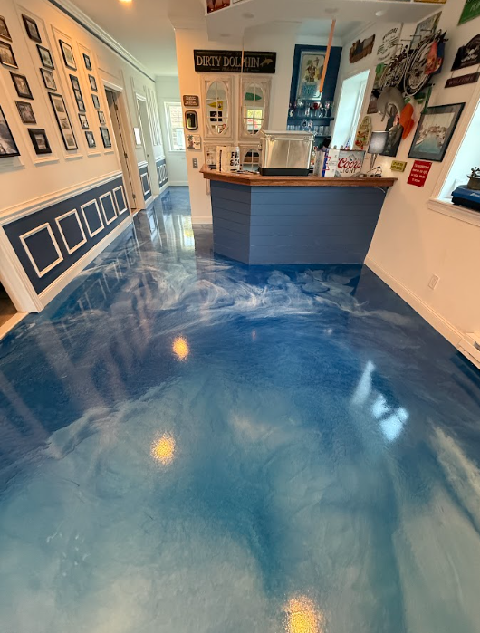Blue metallic epoxy floor in a residential basement bar