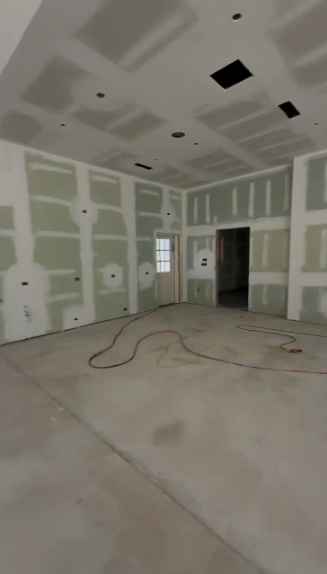 Raw gray concrete slab in an unfinished room before a metallic epoxy coating