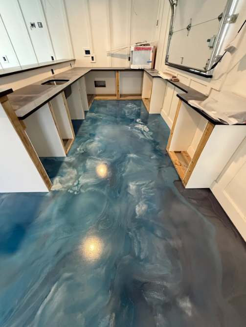 Swirling blue and silver metallic epoxy floor in a residential kitchenette and bar area